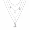 AOI celestial key and moon layered necklace on a clean white background