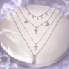AOI celestial layered necklace in a MIRLINKS Y3K editorial
