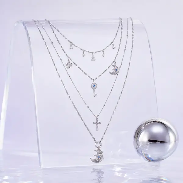 AOI celestial layered necklace in a silver chrome Y3K editorial
