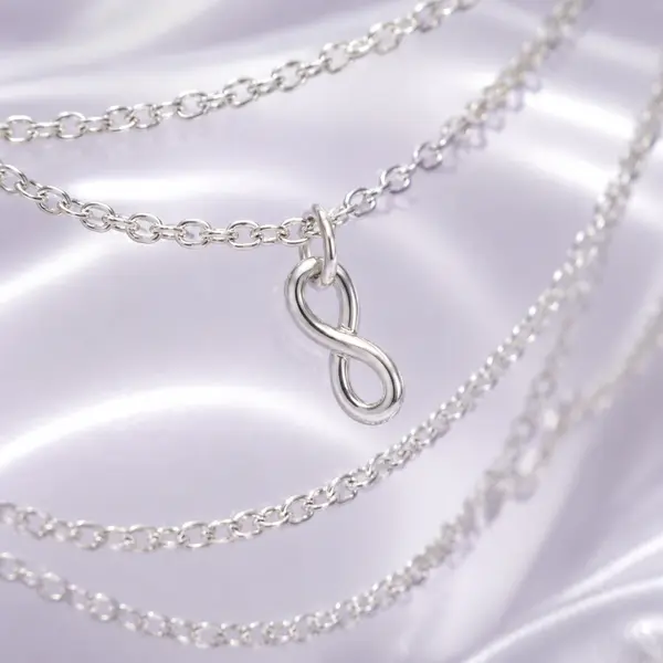 Macro detail of the silver music-note charm and fine chain