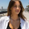 Gen Z woman wearing the AOI layered necklace outdoors by the coast