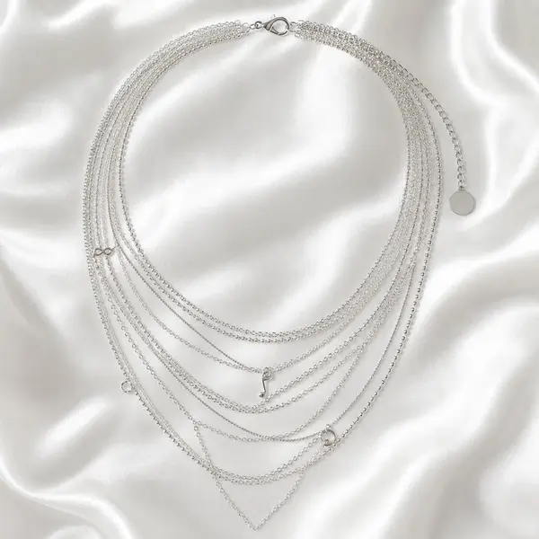 AOI multi-layer silver necklace arranged on pearl satin