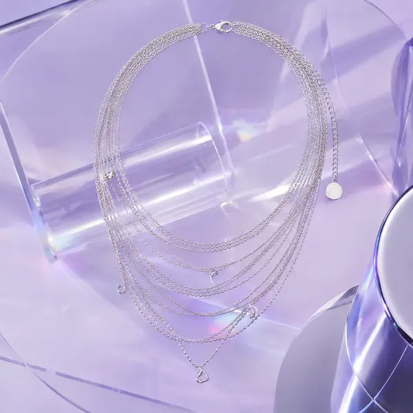 AOI layered necklace in a Future Lilac Y3K silver chrome editorial