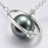 Macro detail of the dark sphere, silver orbital ring and clear accents