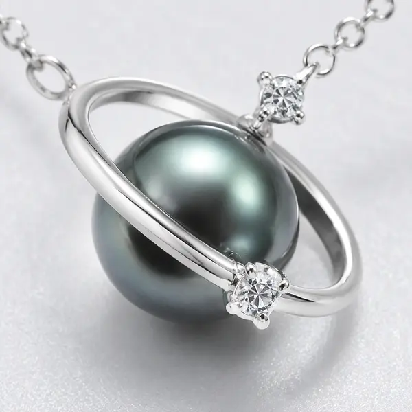 Macro detail of the dark sphere, silver orbital ring and clear accents