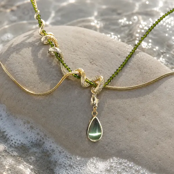 ISLA olive-green teardrop necklace in a natural coastal jewelry editorial