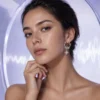 Gen Z model wearing Celestial Starburst Hoop Earrings | Silver-Tone Pavé Drop Earrings in a refined future-lab setting