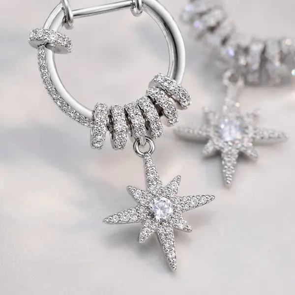 Macro jewelry detail of Celestial Starburst Hoop Earrings | Silver-Tone Pavé Drop Earrings
