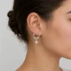 Scale and fit view of Celestial Starburst Hoop Earrings | Silver-Tone Pavé Drop Earrings