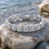 RHEA cushion halo bracelet in a natural coastal jewelry editorial