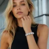 Gen Z woman wearing the RHEA cushion halo zircon tennis bracelet